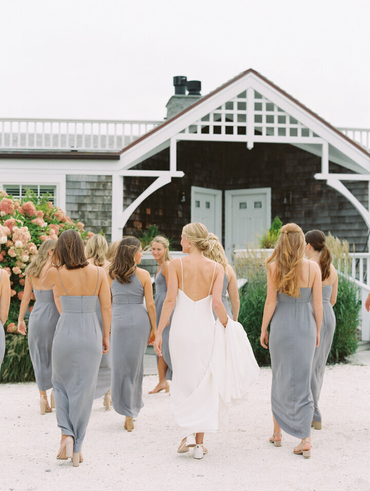 bridal party wearing grey dresses walking at newport castle hill inn