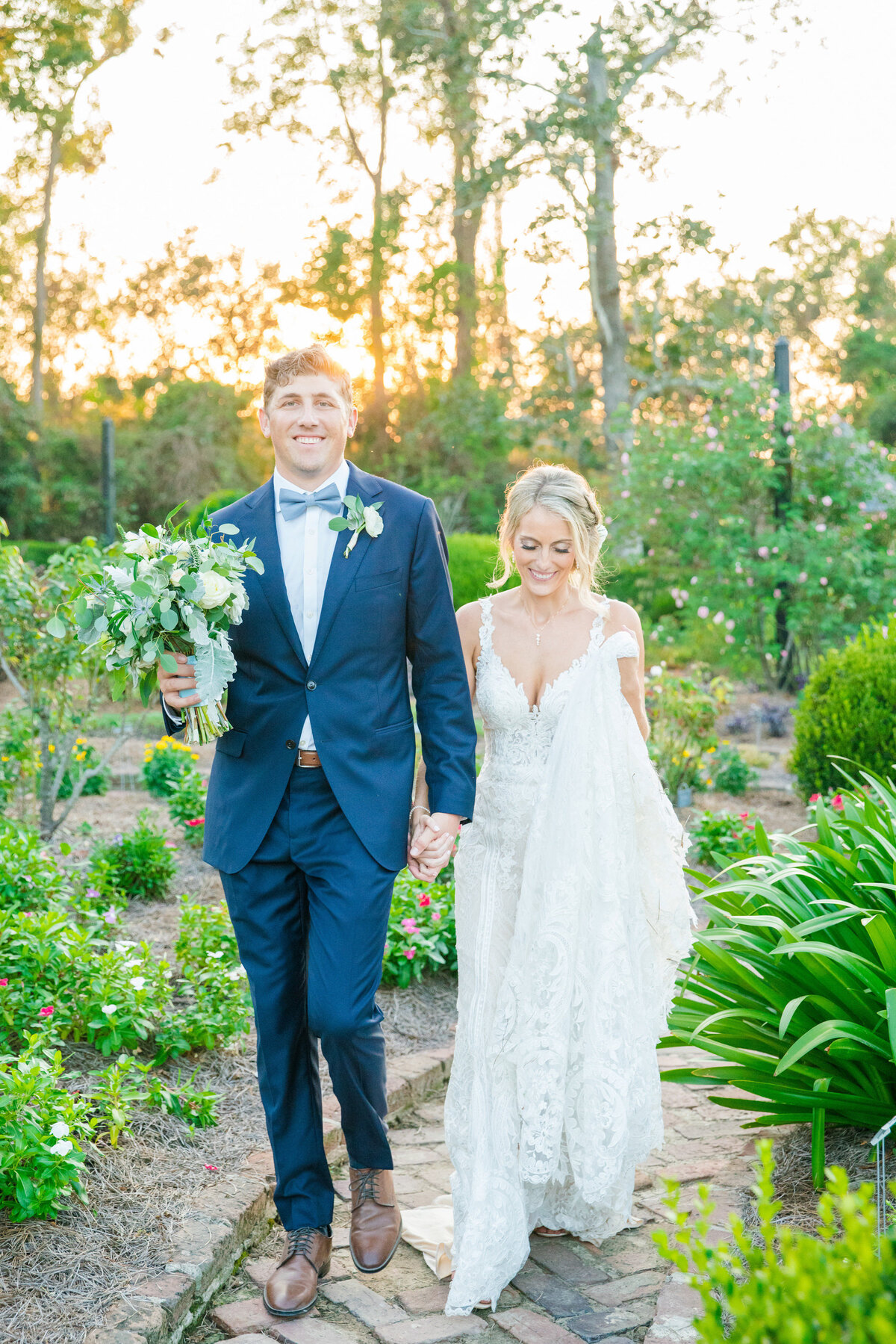 couple walks together at their boone hall wedding