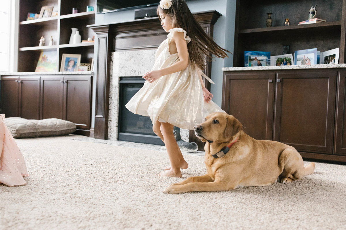 little girl dancing around her puppy