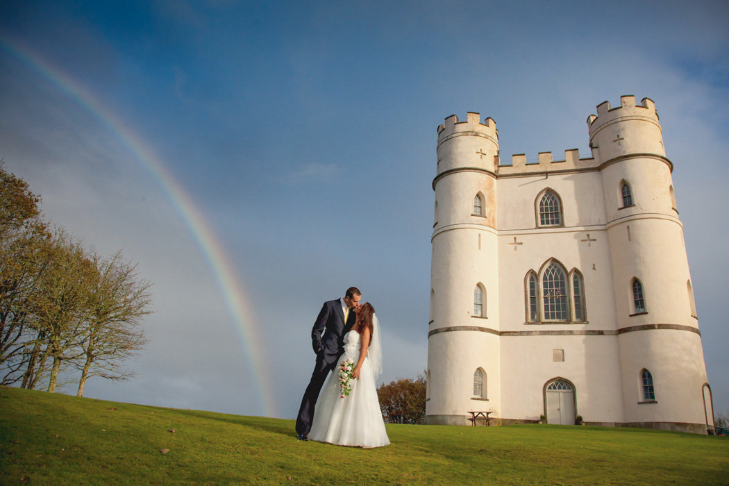 Wedding couple with stunning rainbow over Haldon Belvedere Wedding in Devon