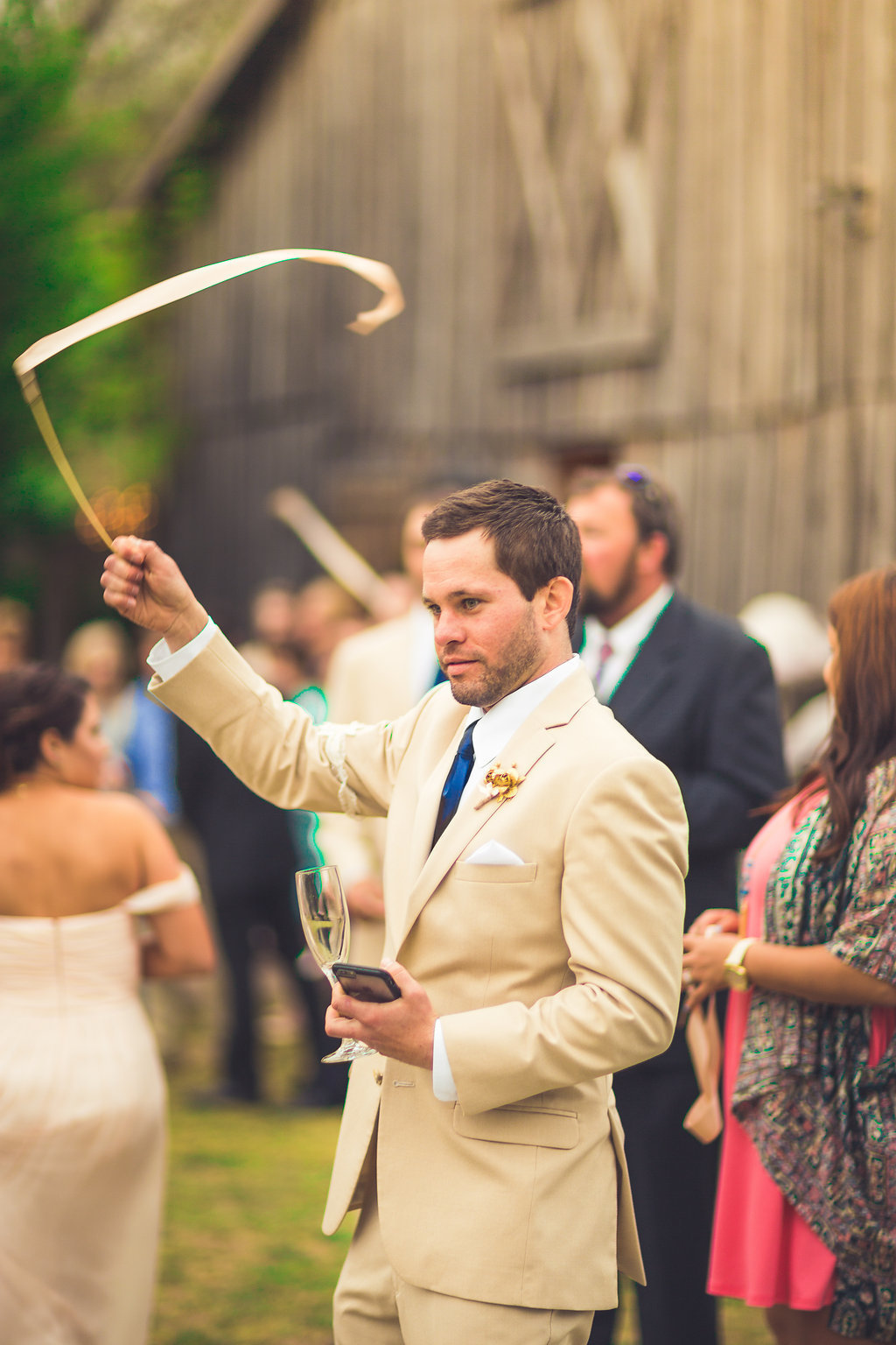 Wedding Photograph Of Man in Light Brown Suit Waving His Wedding Wand Los Angeles