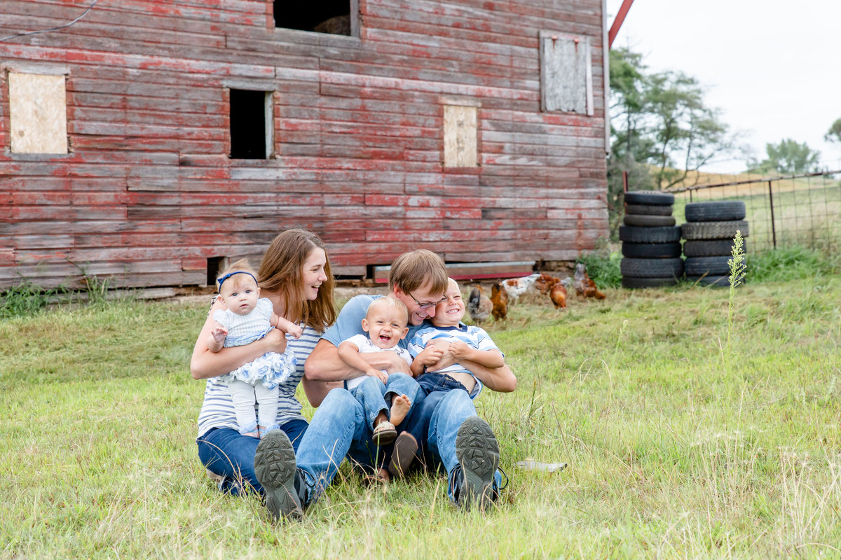 Candid family moment in front of family barn