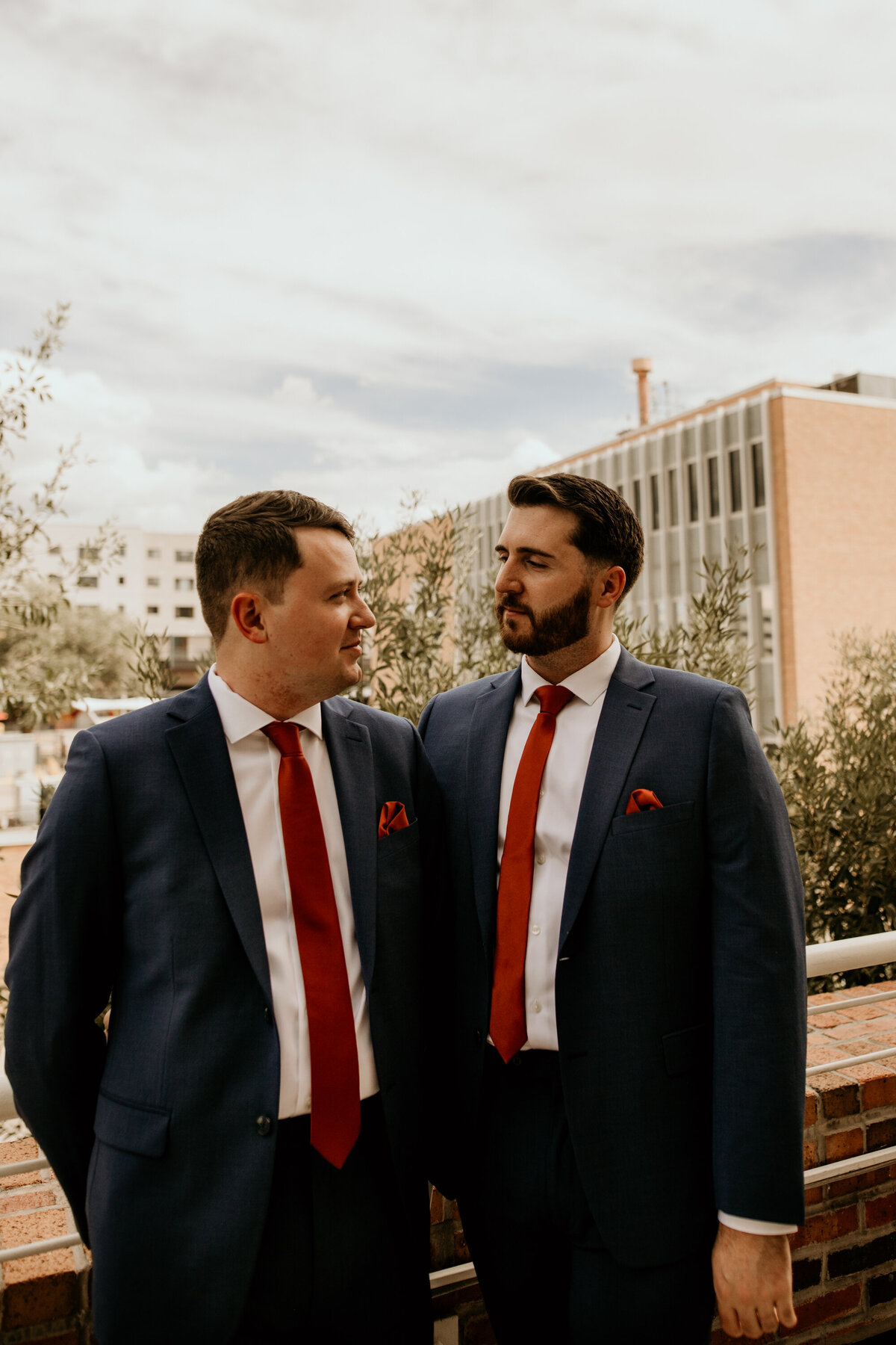 two grooms standing on a balcony in downtown Albuquerque