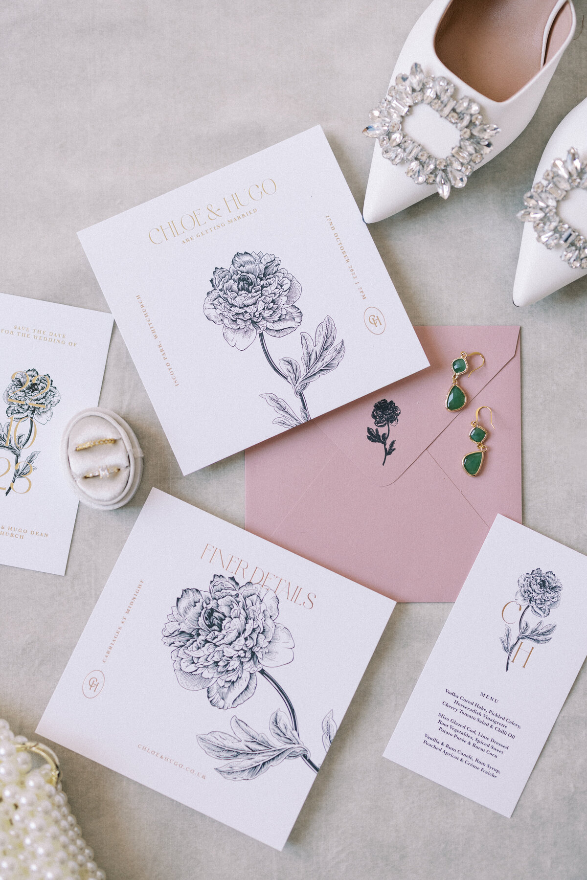 Flat lay photograph of wedding day stationery and details