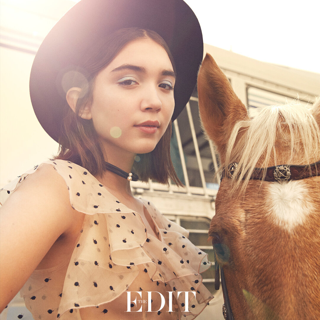 Rowan Blanchard  standing with a horse for the edit