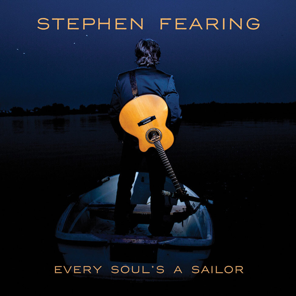 Album Cover Title Every Souls A Sailor Artist Stephen Fearing standing on small row boat facing away from camera acoustic guitar slung across his back lit up at night