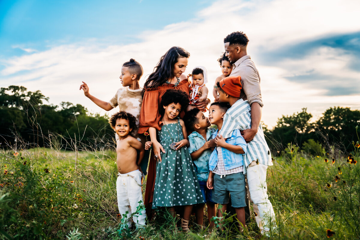 Family Photographer,  Mom and dad are out in nature with their eight young kids