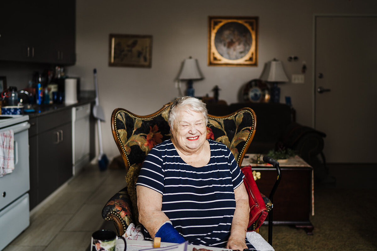 Woman smiles in her home during a portrait session in Chattanooga, TN.