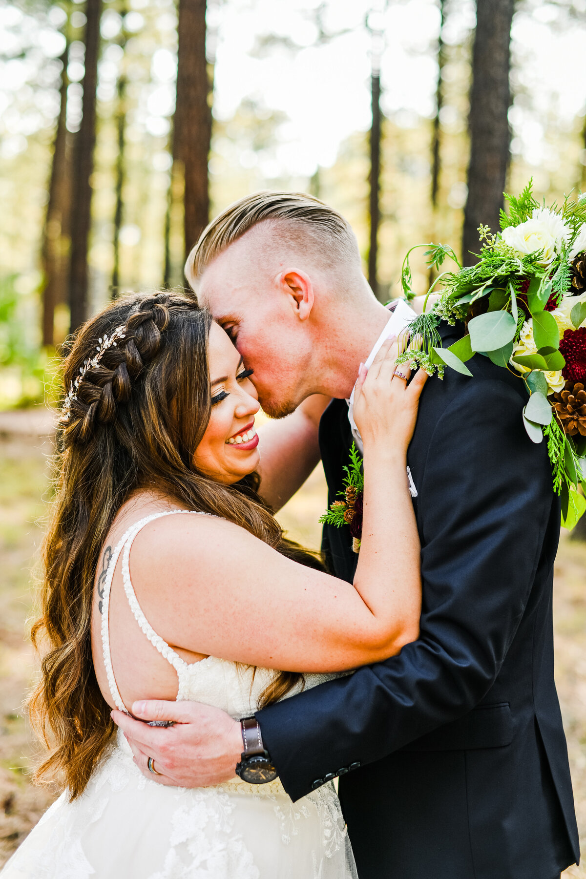 Bride and groom kissing cheek smiling pine trees The Gathering Place Pinetop
