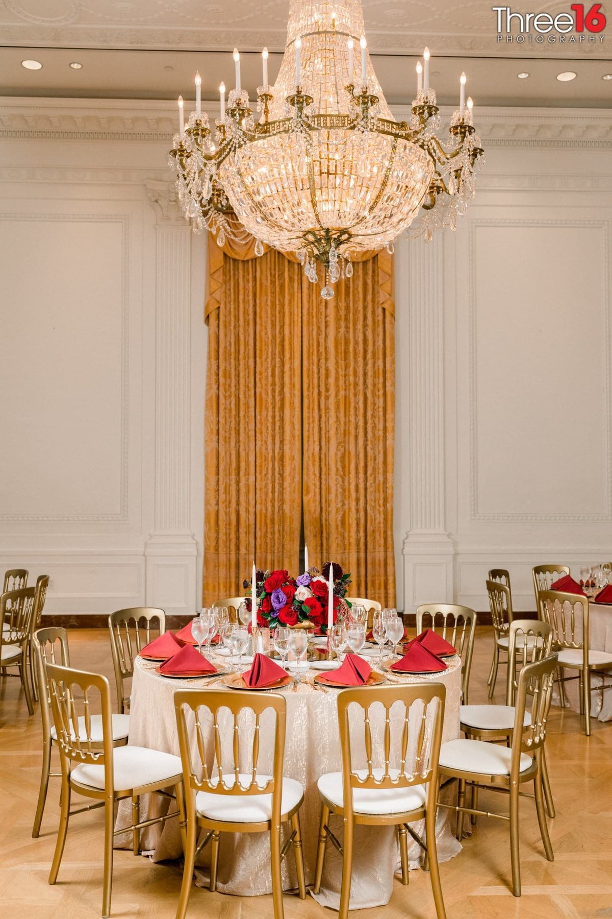 Richard Nixon Library wedding reception table display with long vertical drapes in the background