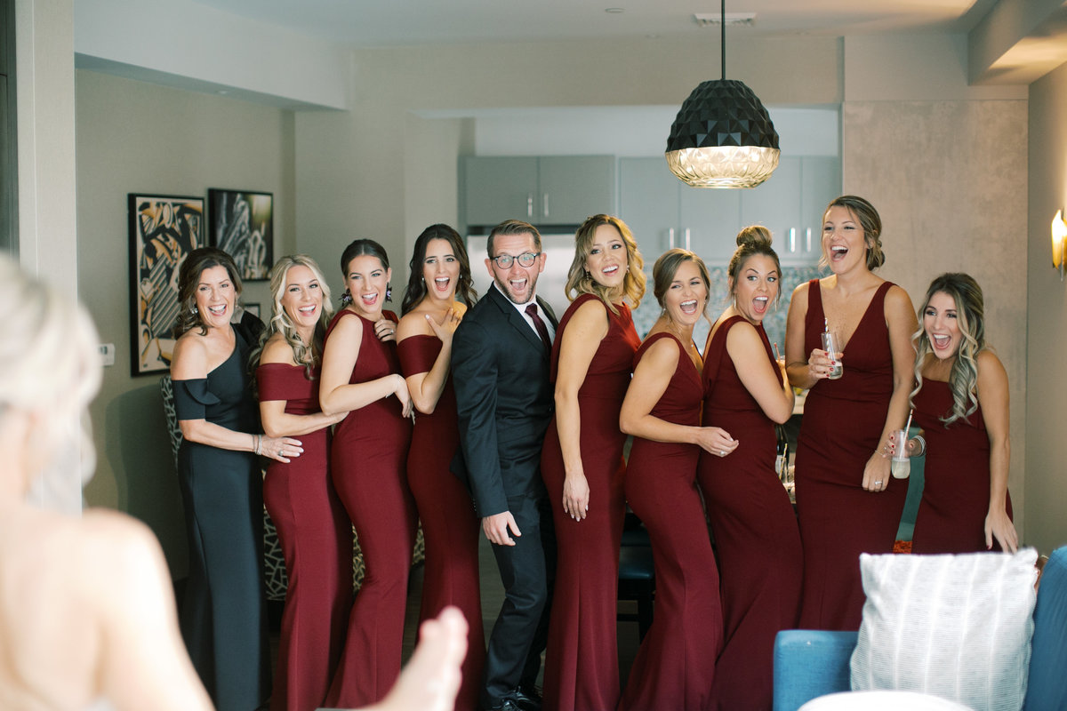 bridesmaids wearing burgundy and navy gowns