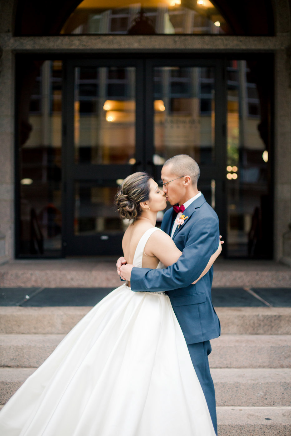 landmark center outdoor steps recently eloped couple kisses