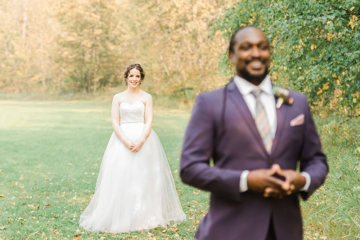 First look of an interracial wedding couple at West River's Edge in Fort Saskatchewan, Alberta