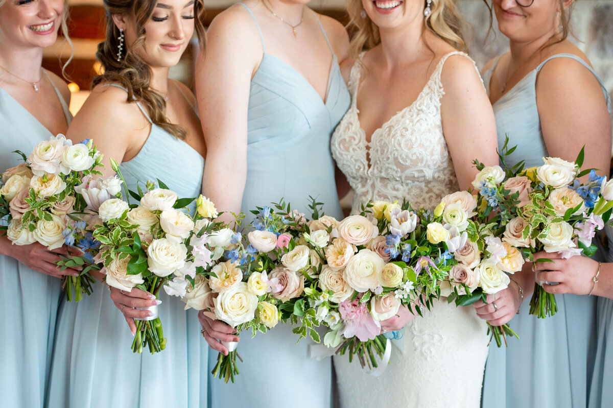 Ottawa wedding photography showing a closeup photo of multiple bridesmaid bouquets in a row at Stonefields Estate wedding venue