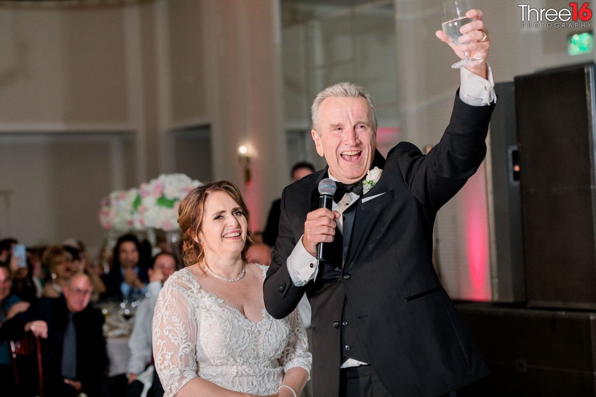 Bride and Groom toasts others at the wedding reception