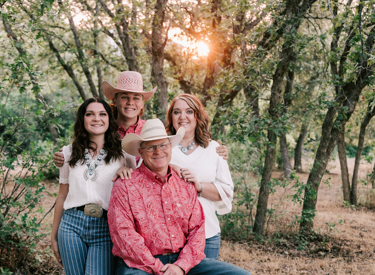 A family wearing cowboy hats at sunset. Photography by Diane Owen.