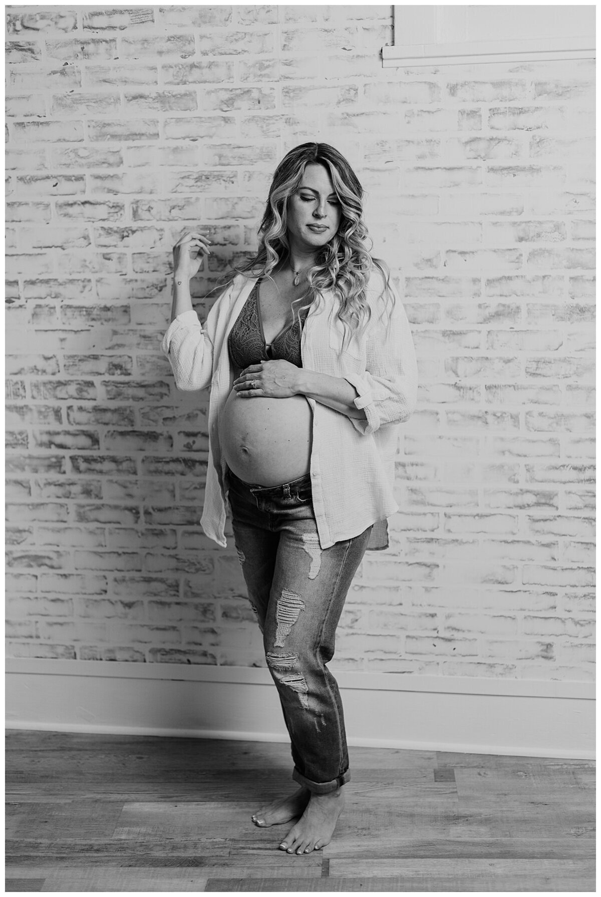 Mom to be showing off her beautiful baby bump in a cute top and jeans during a maternity photoshoot in studio in Wexford PA
