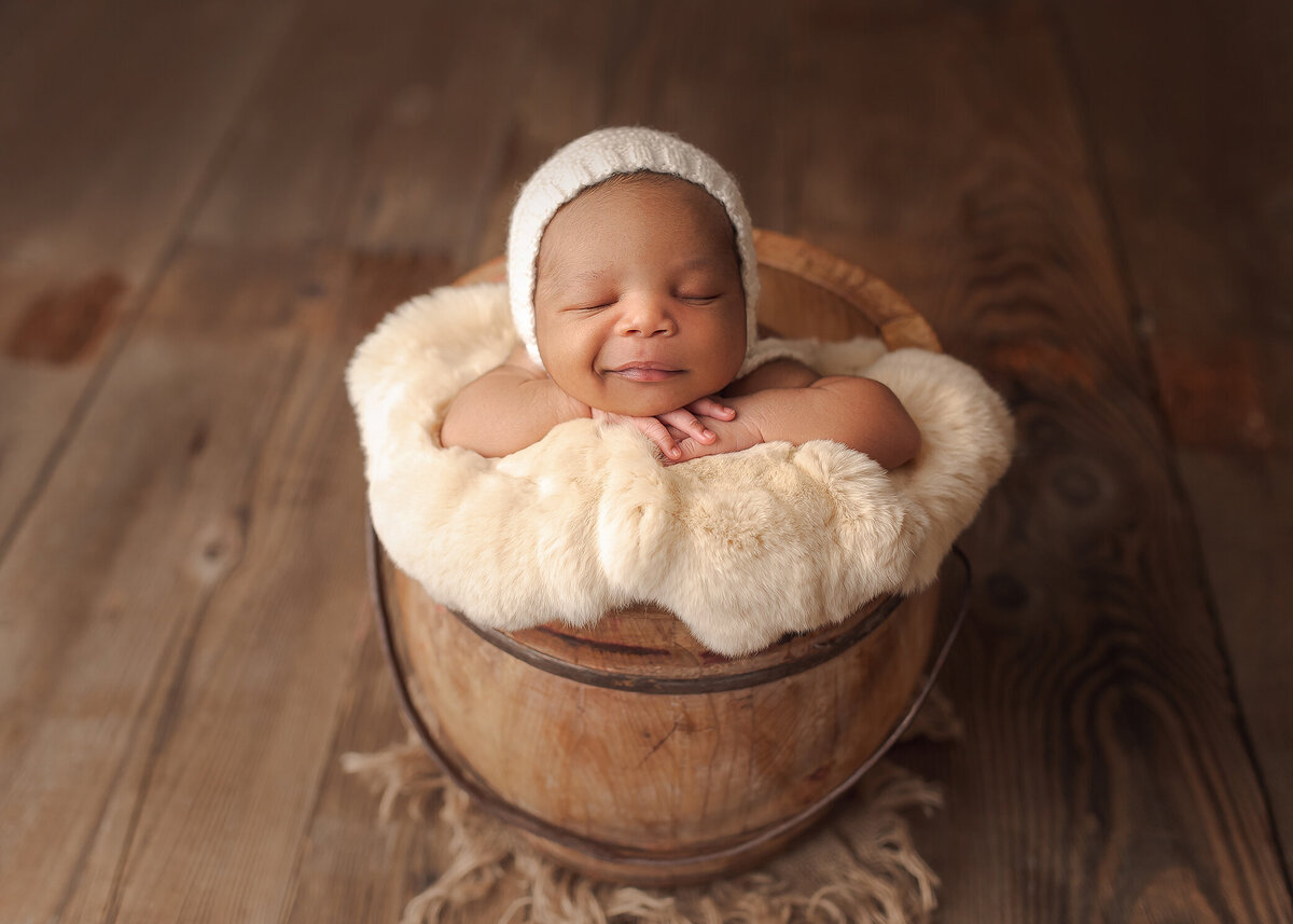 Happy newborn posing in bucket, Southern Oregon newborn photographer, Katie Anne