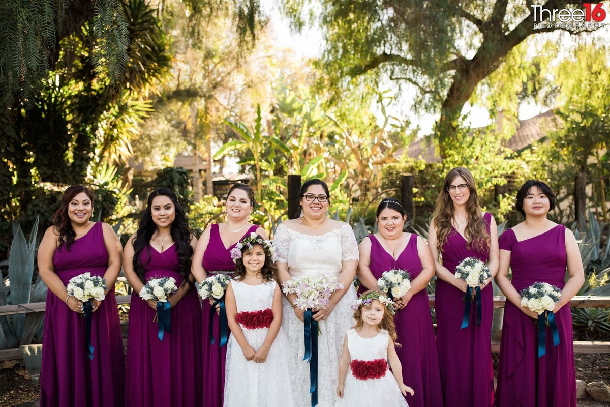 Bride, Bridesmaids and Flower Girls all pose together
