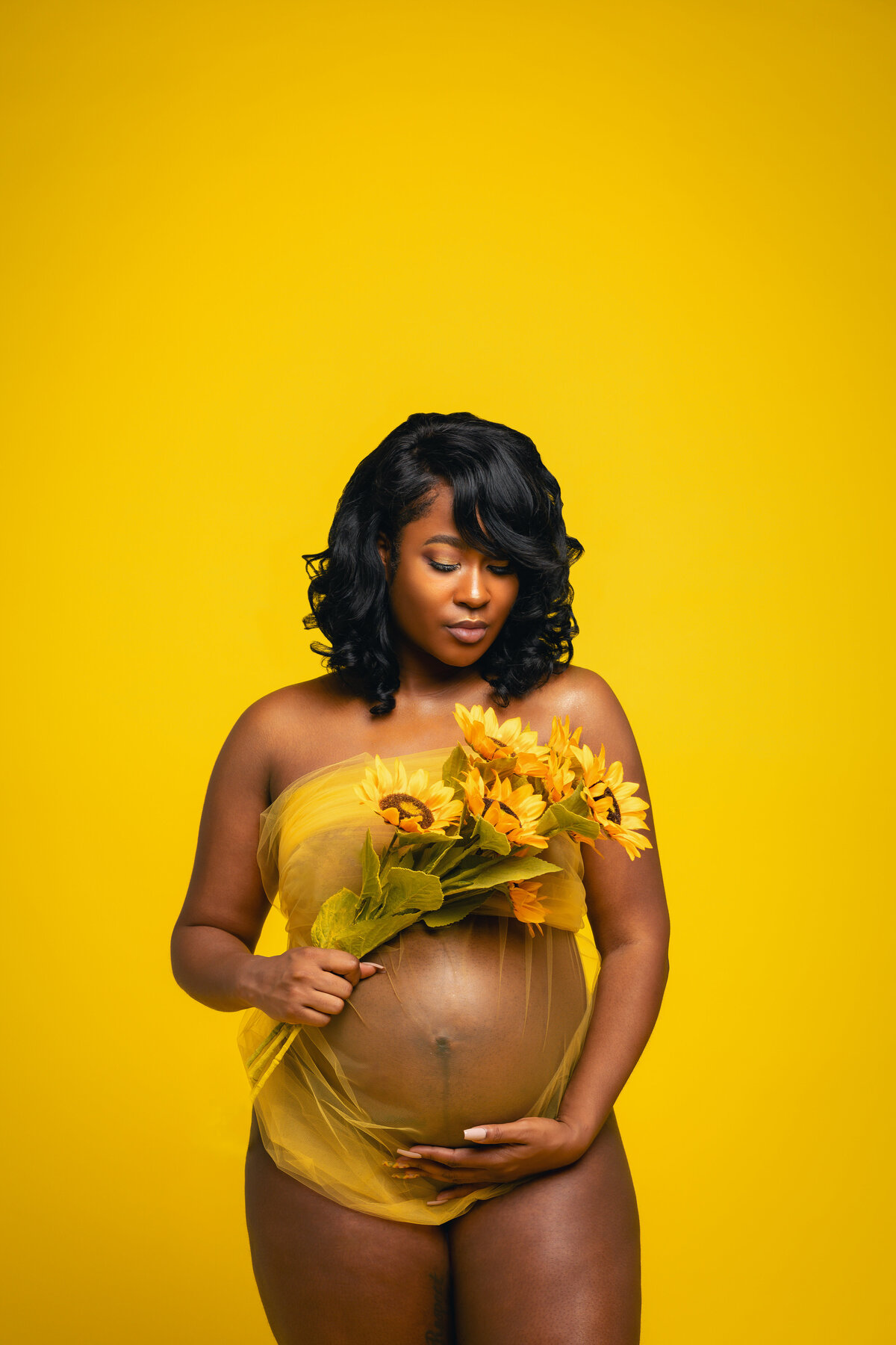 Black pregnant mom to be in yellow lace with sunflowers