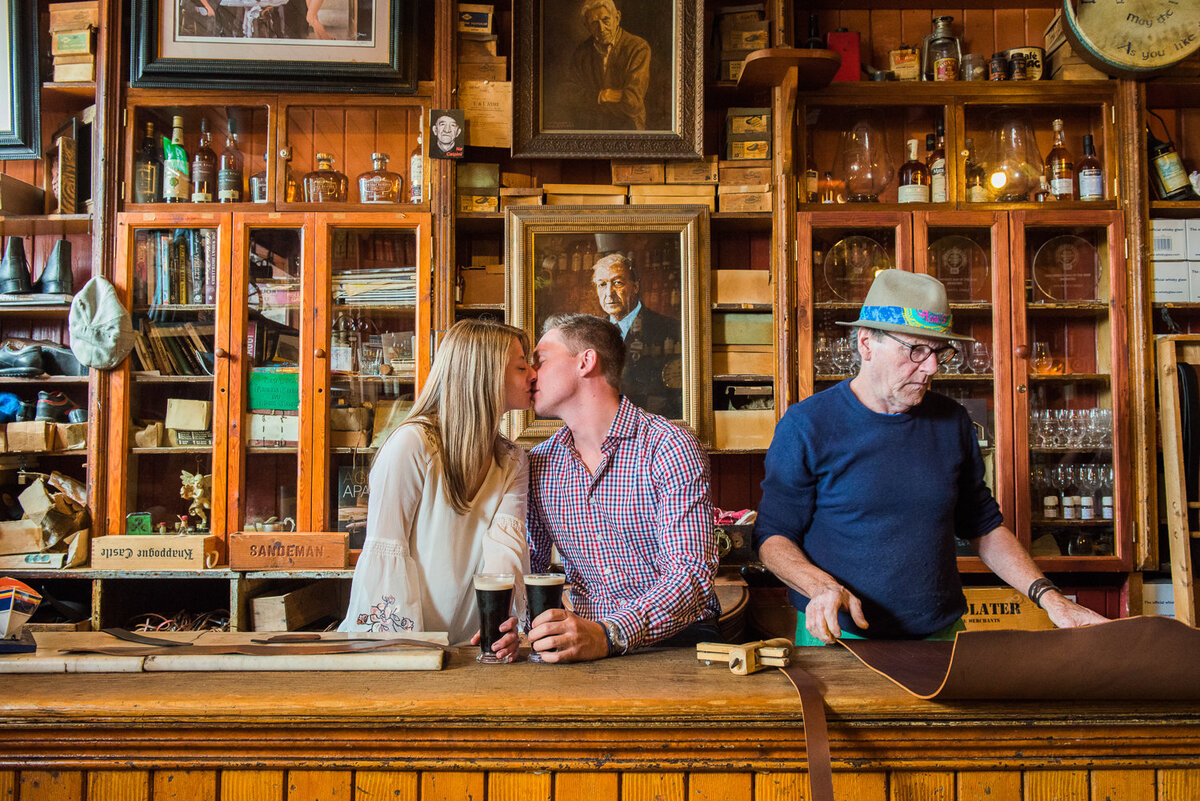 Young couple kissing in an traditional Irish pub in Dingle