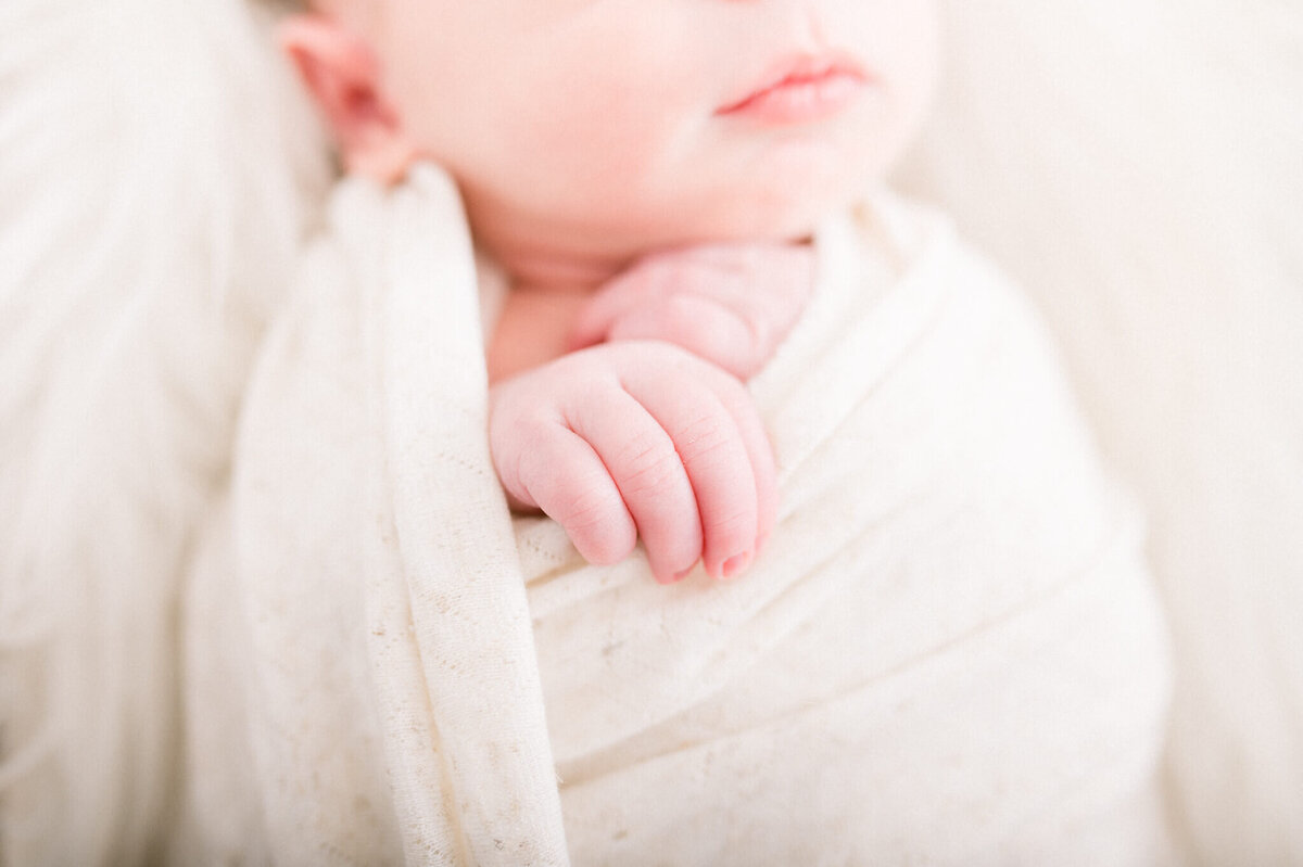 Niagara newborn photography of close up of newborn hands while baby boy is in a wrap