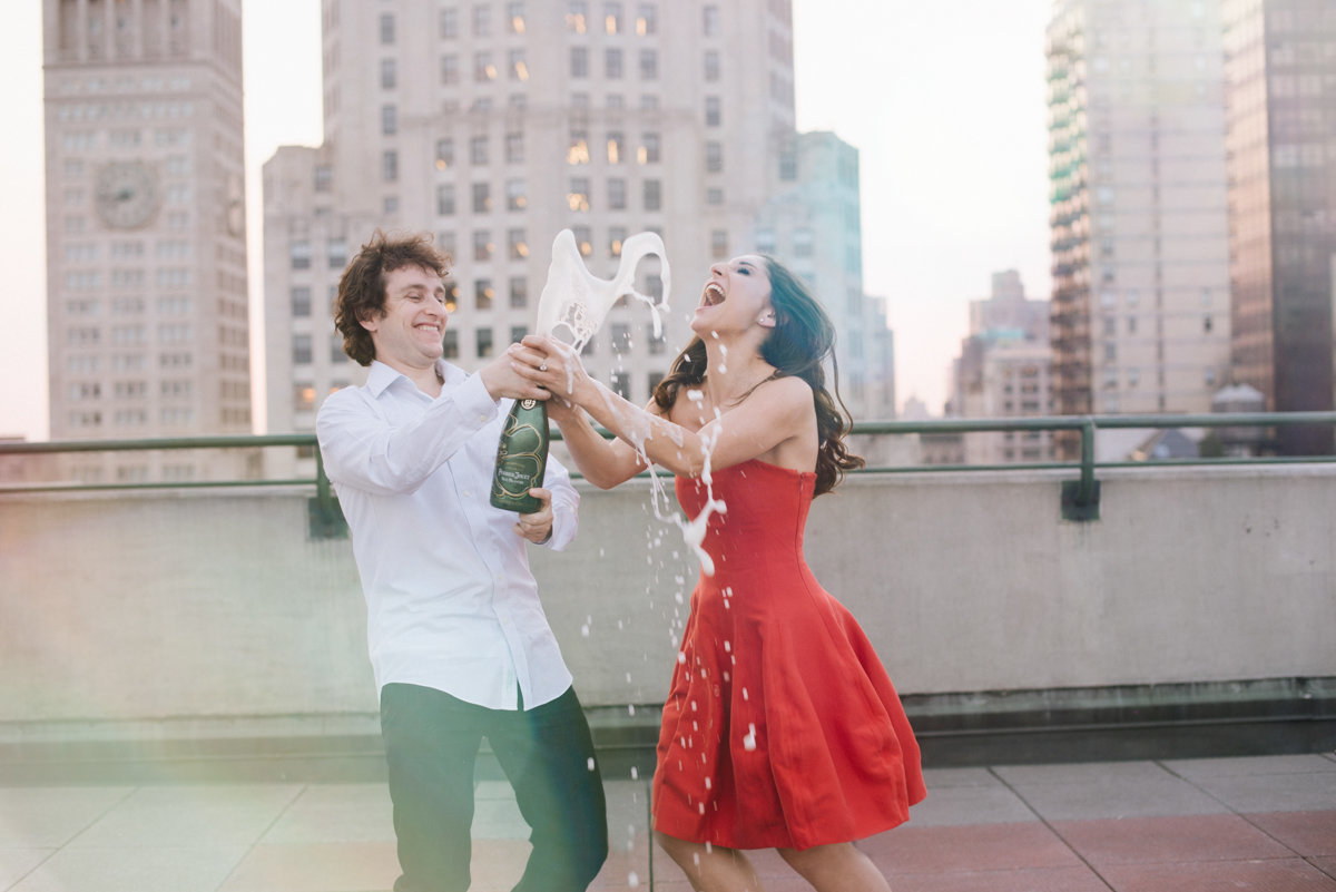 fun nyc engagement rooftop nyc new york city pop champagne skyline