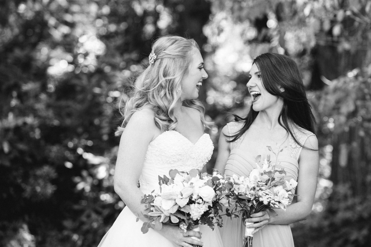 black and white photo of bride with bridesmaid