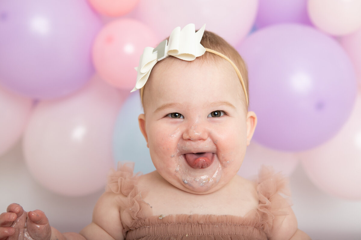 Smiling baby with icing on her face