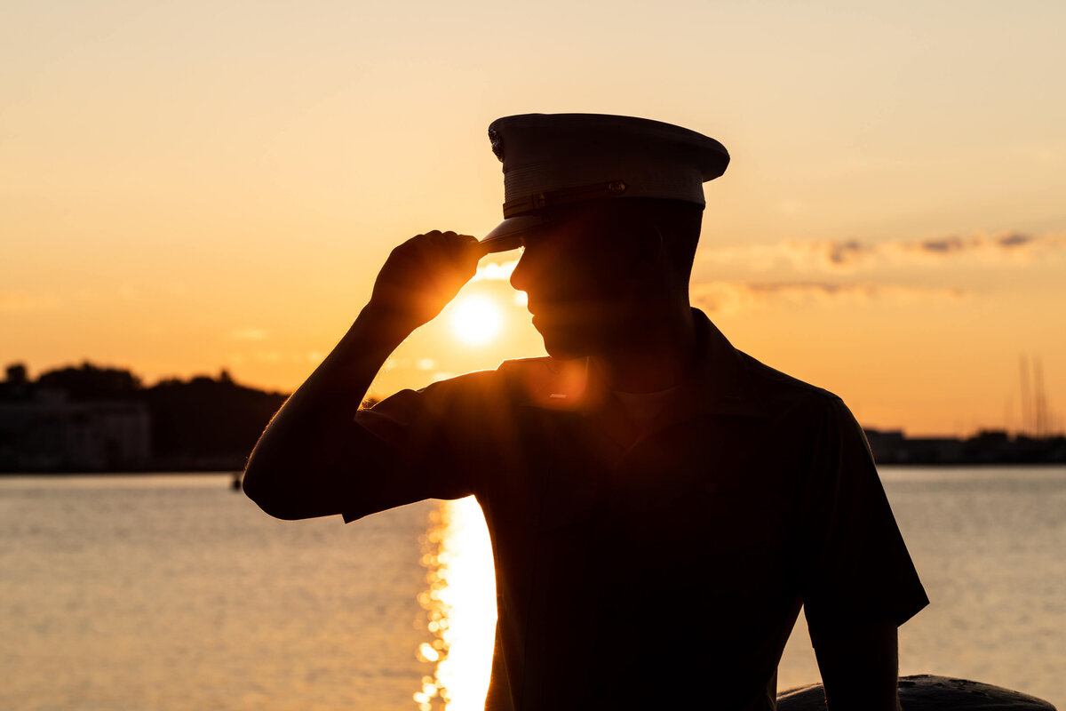 Silhouette of Naval Academy  officer in uniform at sunrise on Chesapeake Bay.