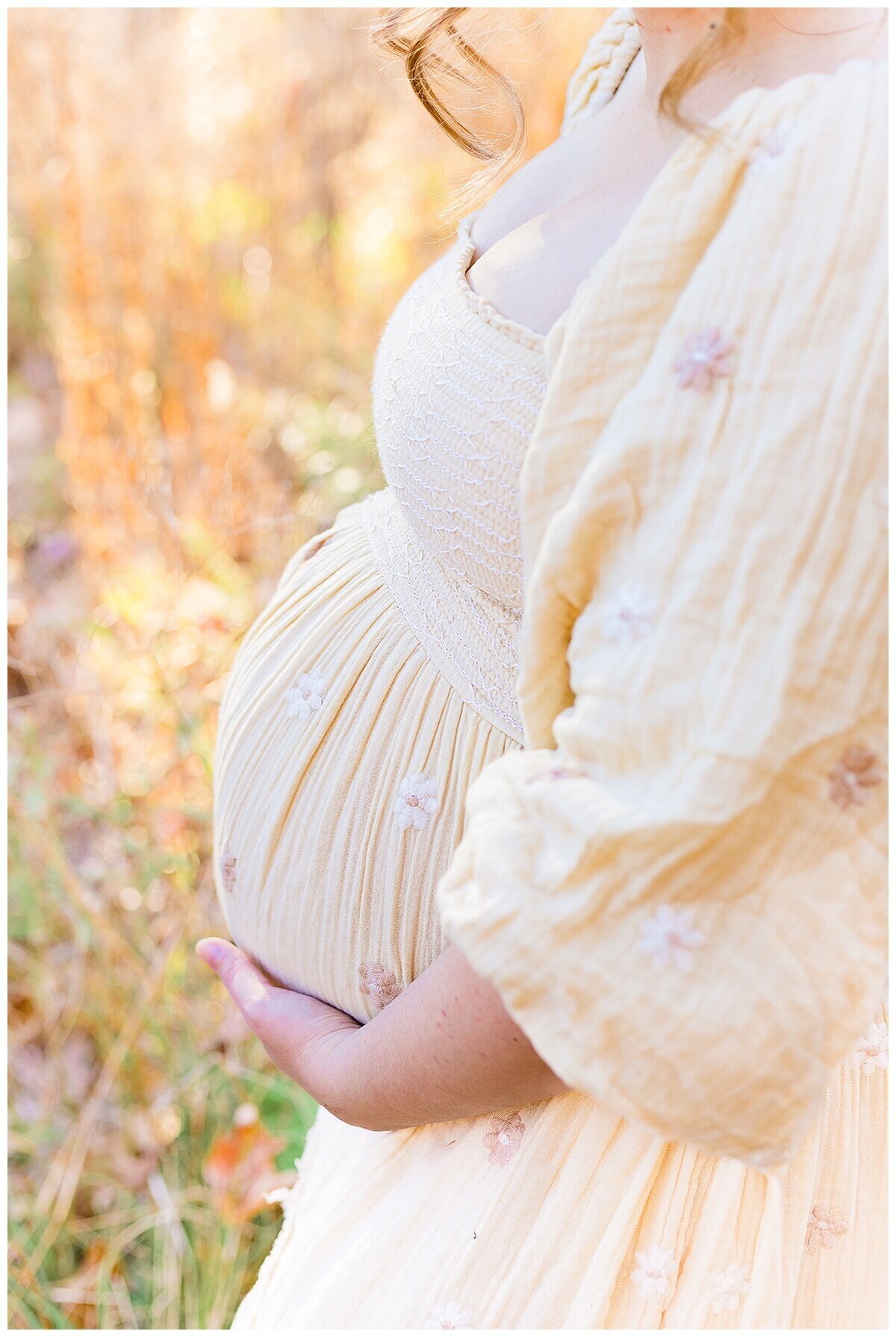 an outdoor Maternity Photography in Wexford where it is golden hour and there is a close up of moms baby belly