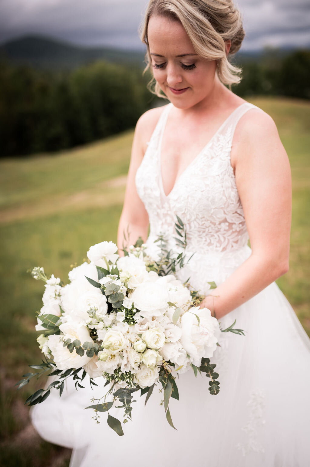 Bride holding her bouquet with white peonies