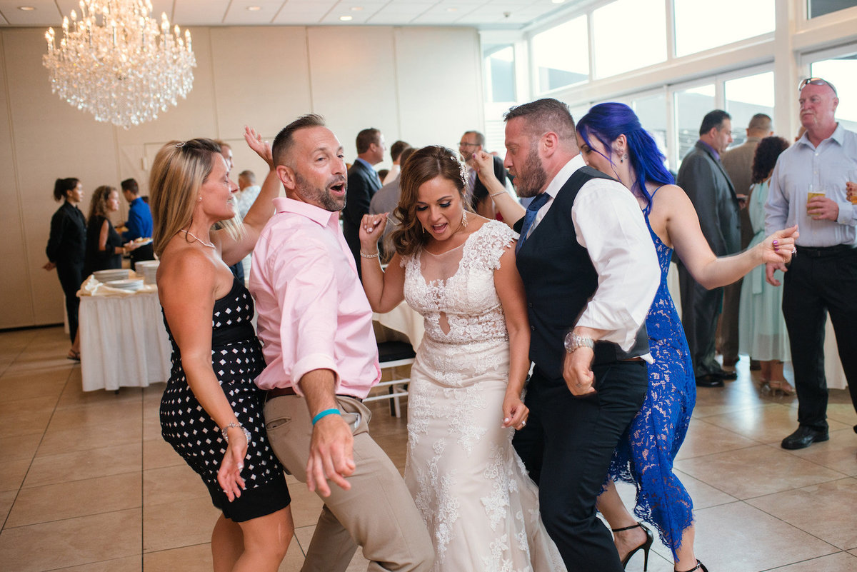 photo of bride and groom dancing with guests during their wedding reception at Lombardi's on the Bay