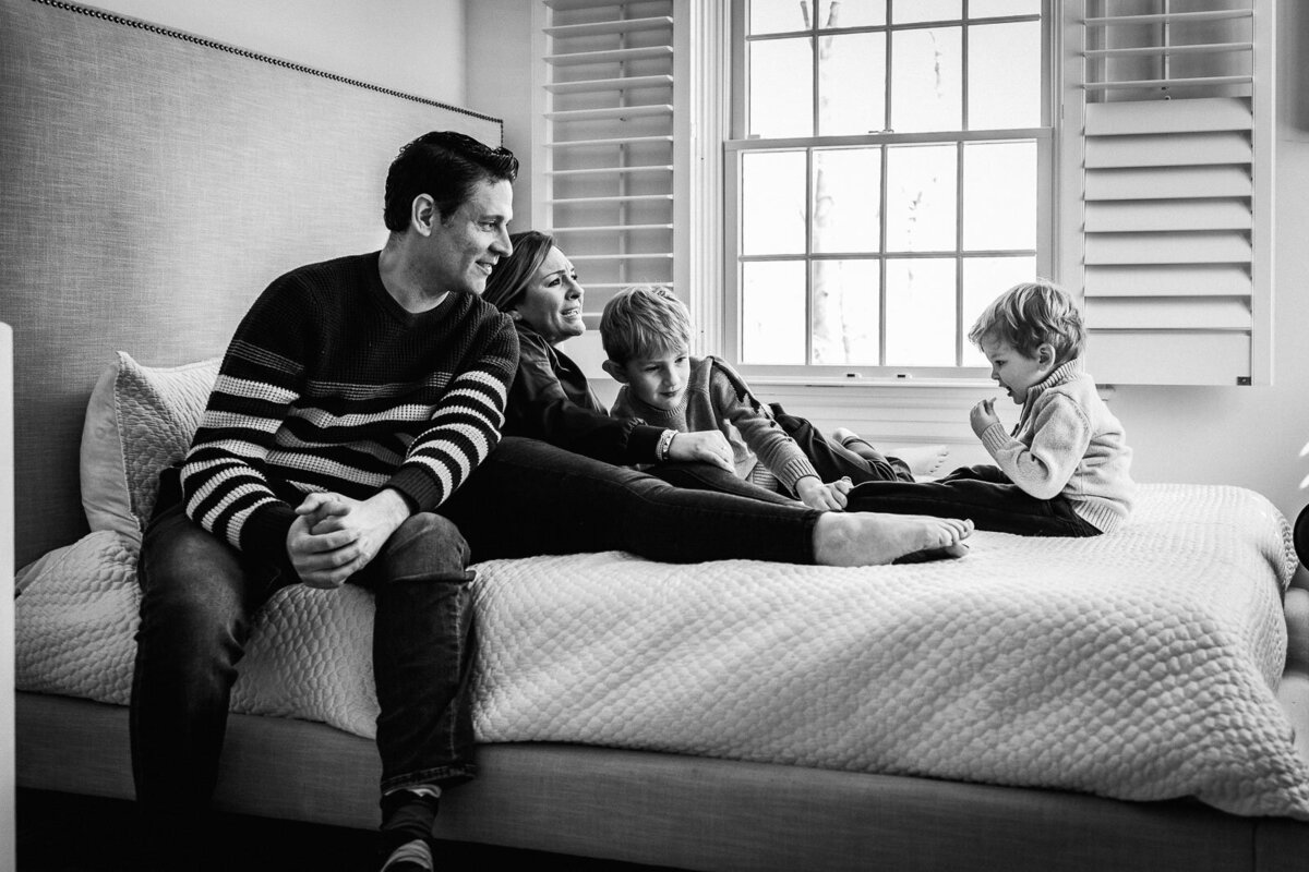family laughing on bed during long island family portraits