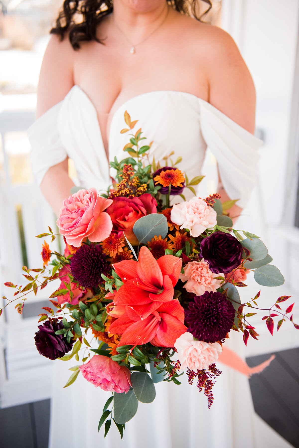 A close up shot of a bride's vibrant, warm colored bouquet.