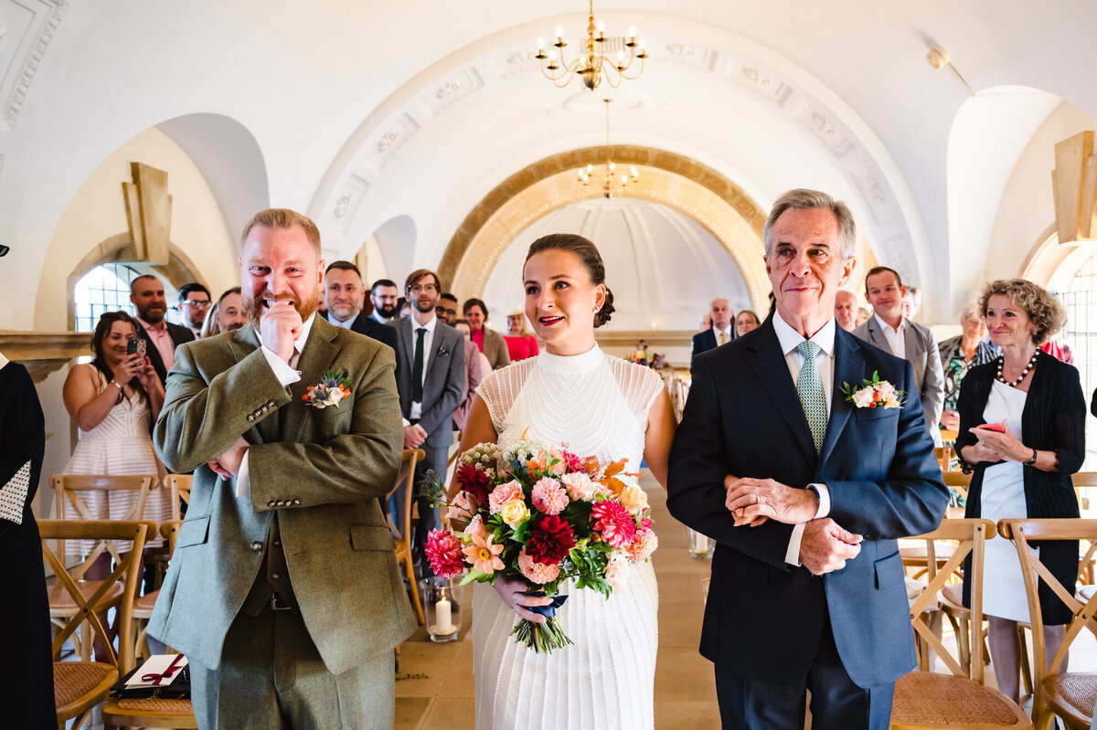 Grooms reaction to bride walking down the aisle at normanton church