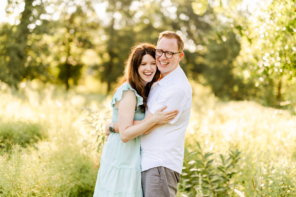 Married couple laughing in a summer field at a Chicago couples photography session.