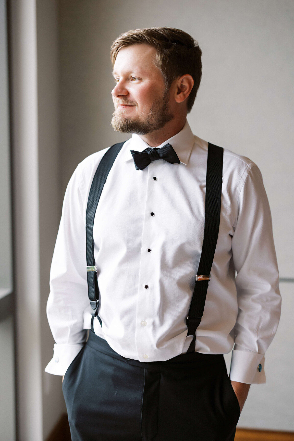 groom in classic suspenders