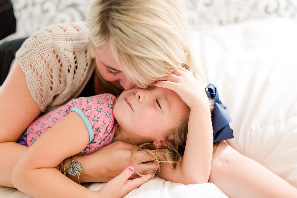 Mom and daughter snuggled up together during an in-home family photo session in KY.