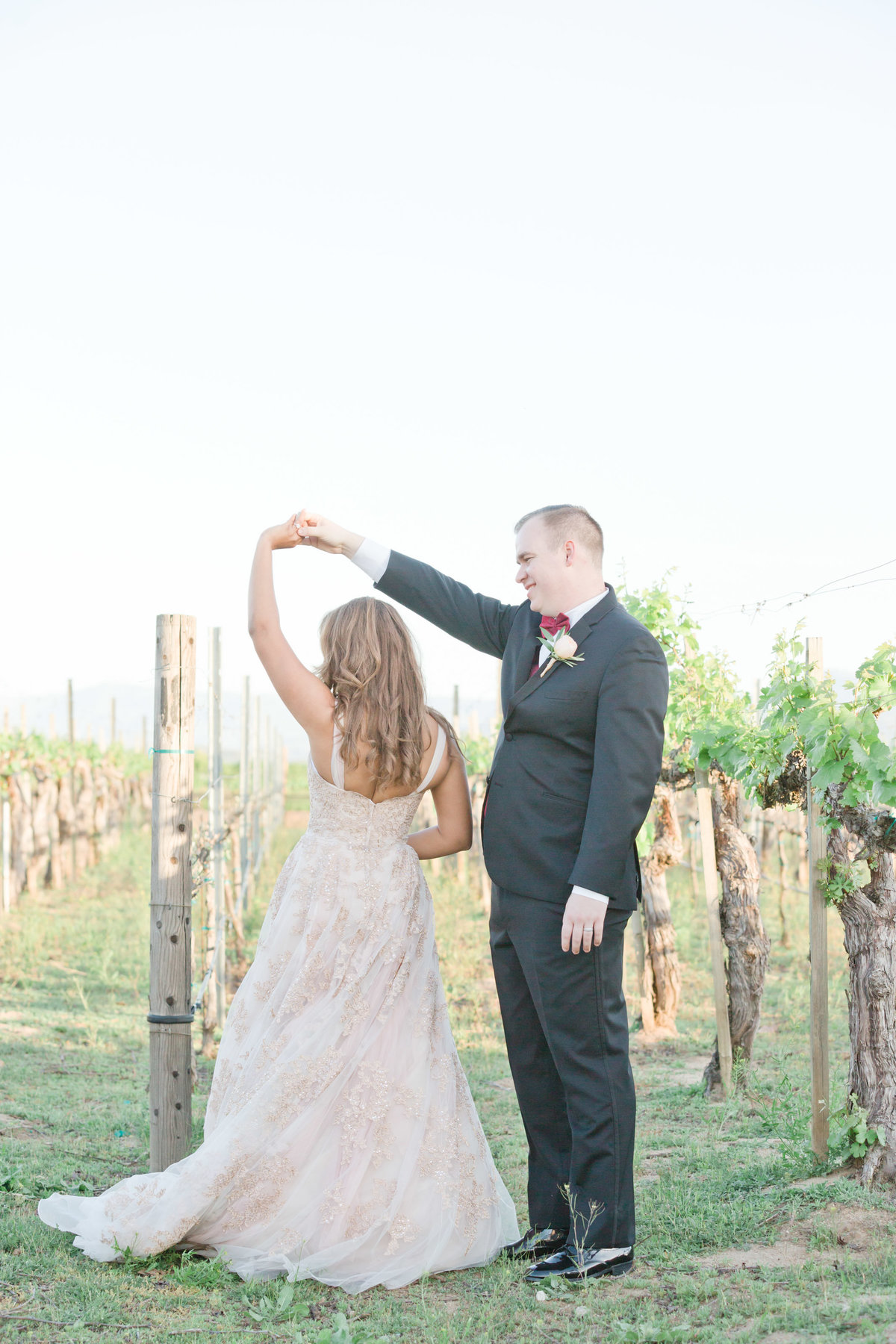 bride and groom dancing in the vineyard in temecula