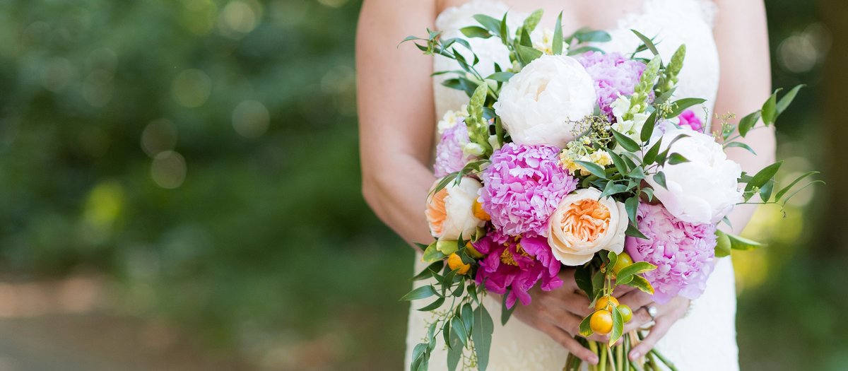 Bride holding beautiful pink peony bouquet photo