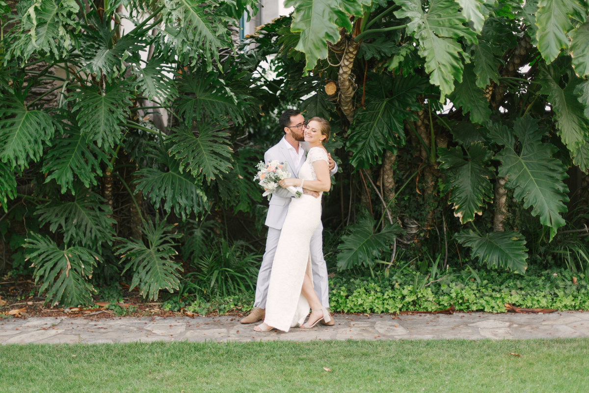 Groom kisses brides cheek at Santa Barbara Courthouse wedding