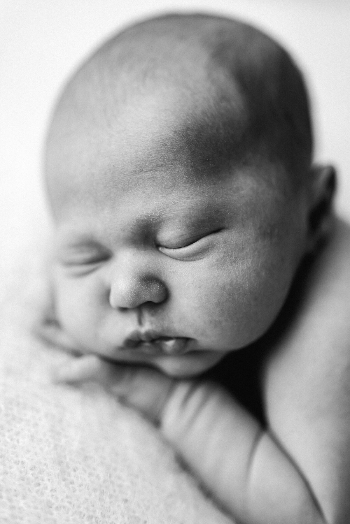 Newborn baby boy sleeping at newborn photoshoot in Billingshurst
