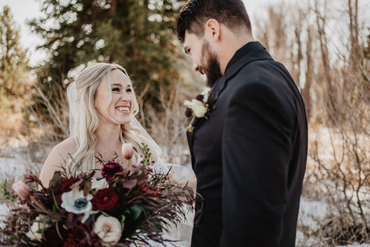 Jackson Hole Photographers capture bride smiling at groom during first look