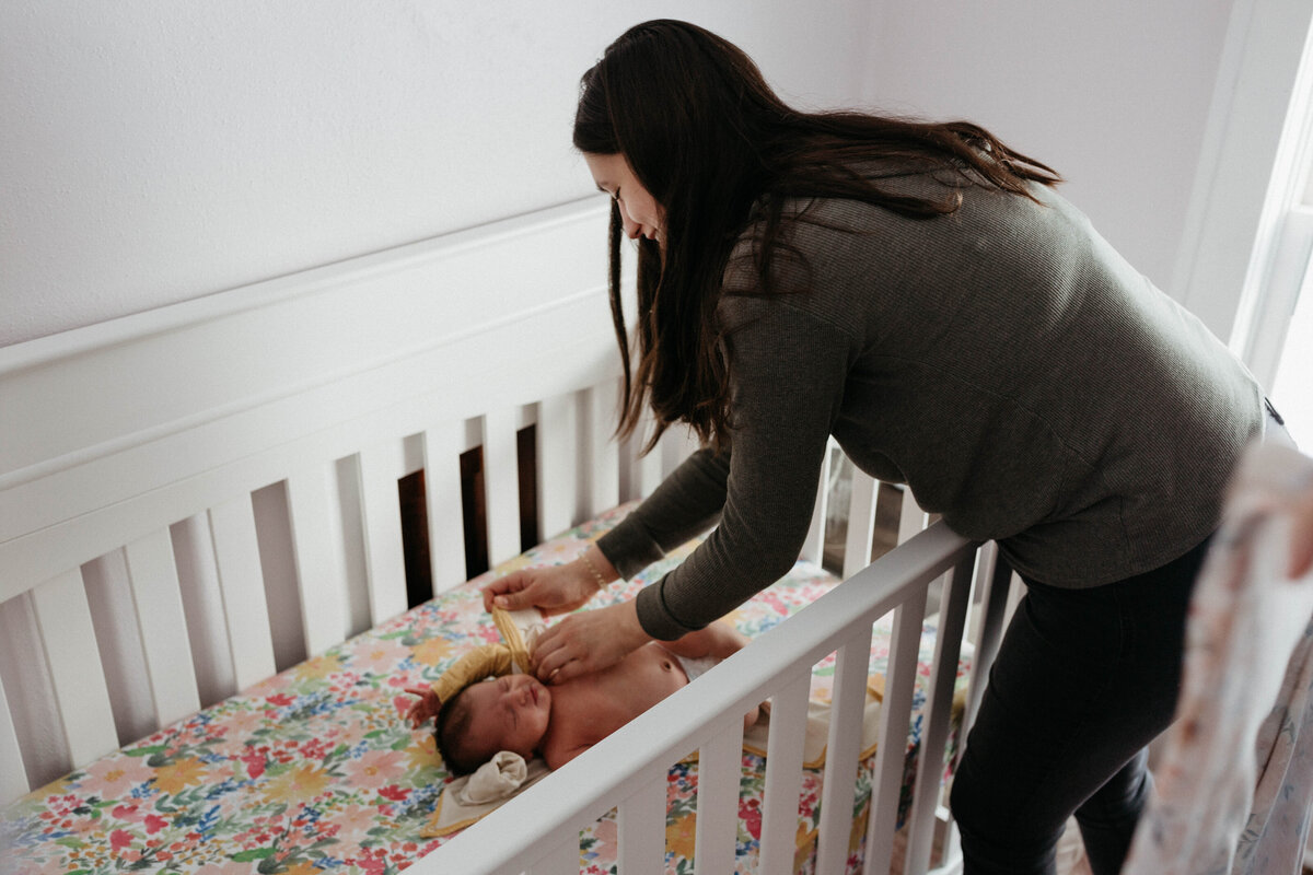 mom-putting-baby-in-crib