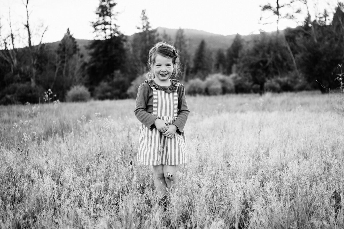 Child in stripes playing in a meadow