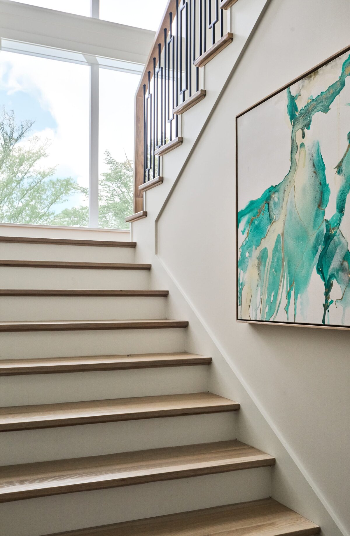 cocoloba homes graham stairs with abstract painting on wall