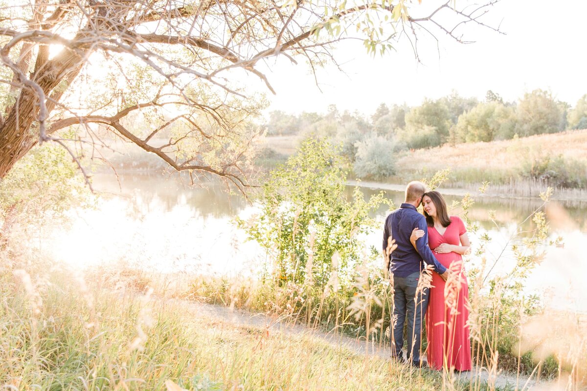 beautiful light wraps around couple and their coming baby at Majestic View Park