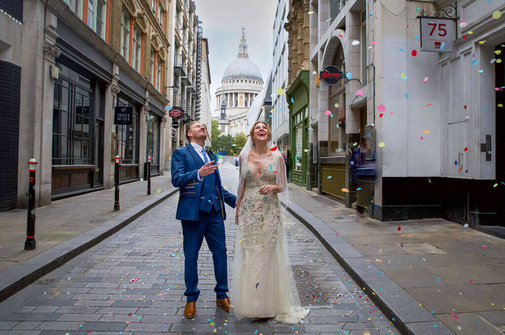 Bride and groom confetti shot infront of St Pauls