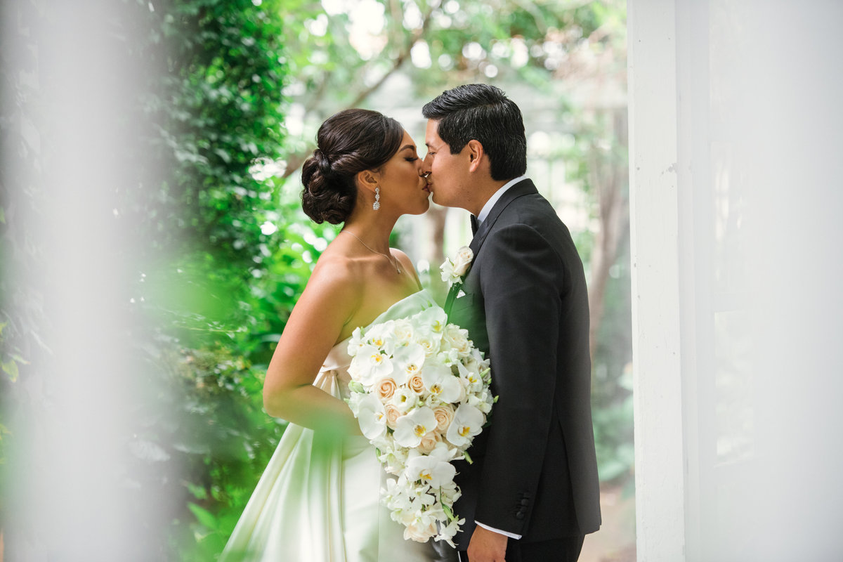 photo of bride and groom kissing outdoors from wedding at The Garden City Hotel